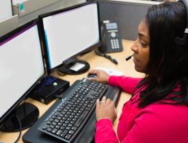 Woman using computer with headset